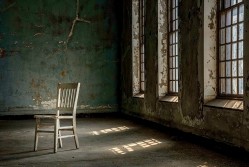 <p>An empty chair in a ward at Ellis Island. Image courtesy of Save Ellis Island.</p>

